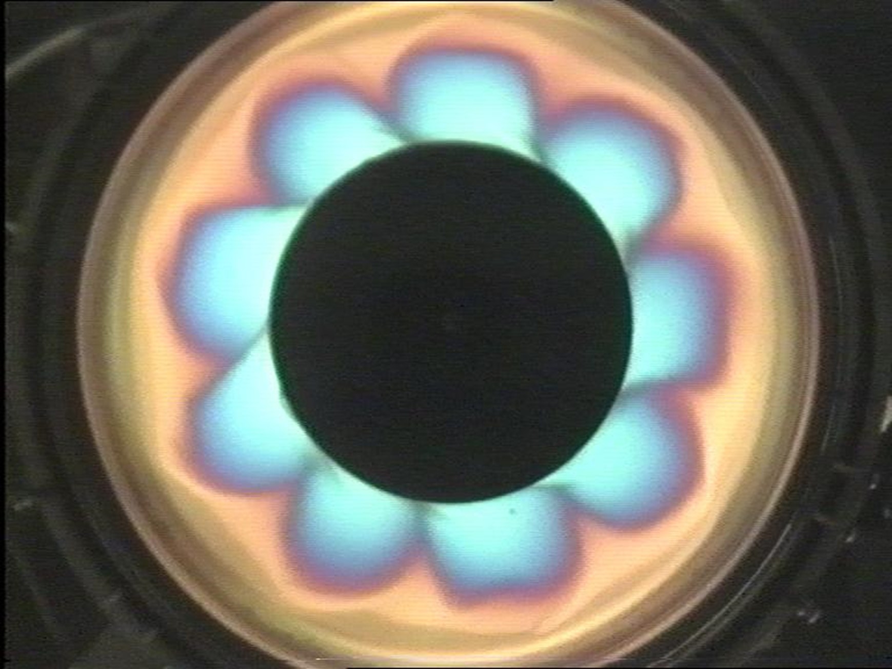 Still from a video of a rotating annulus, with different colours indicating different heights