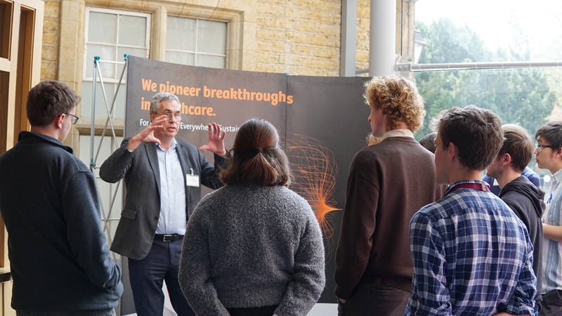 Male talking to students