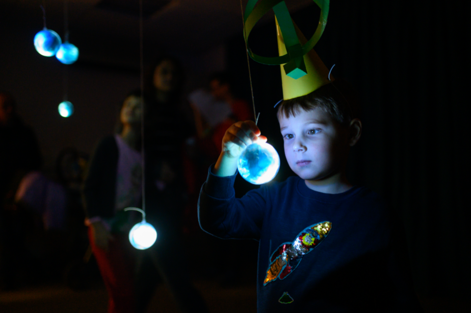 Boy looking at glowing globe