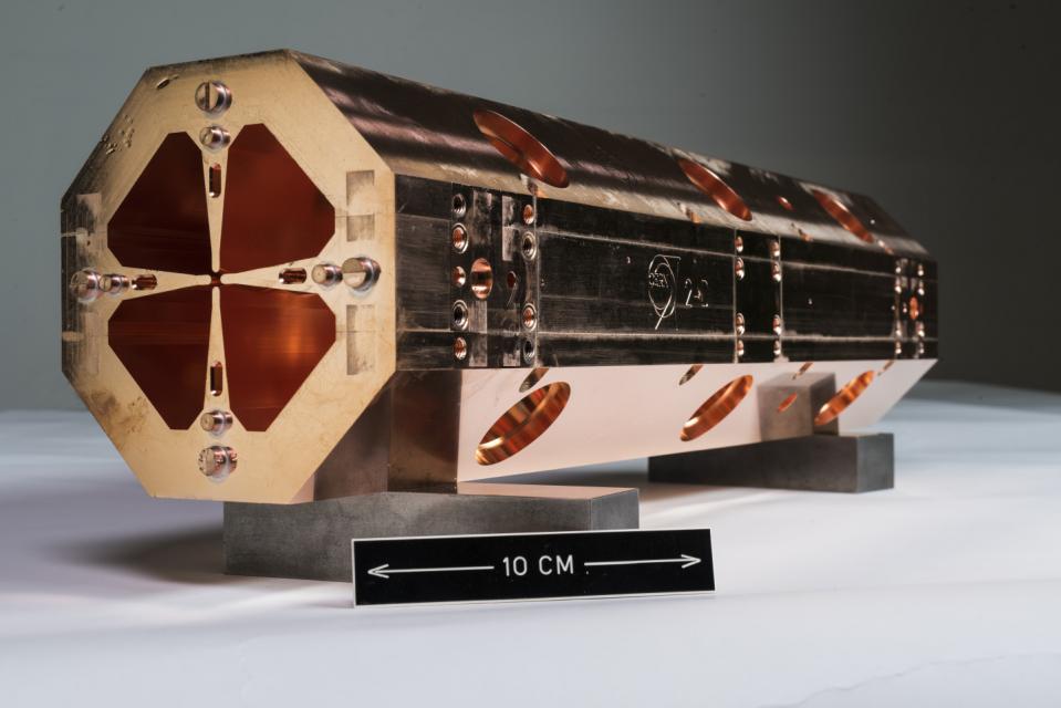 A photograph of a copper radiofrequency quadrupole, a vital component of the NIMMS project
