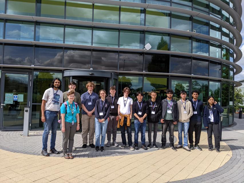 Students standing outside RAL Space building with Raghu and Daisy