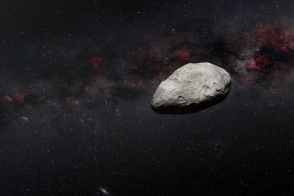 Artist's impression shows a grey, irregularly-shaped asteroid against a dark background.