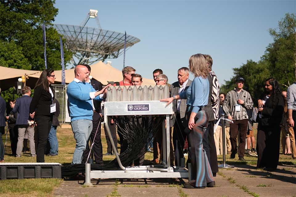 Members of the partnership standing around the phased array feed (PAF).