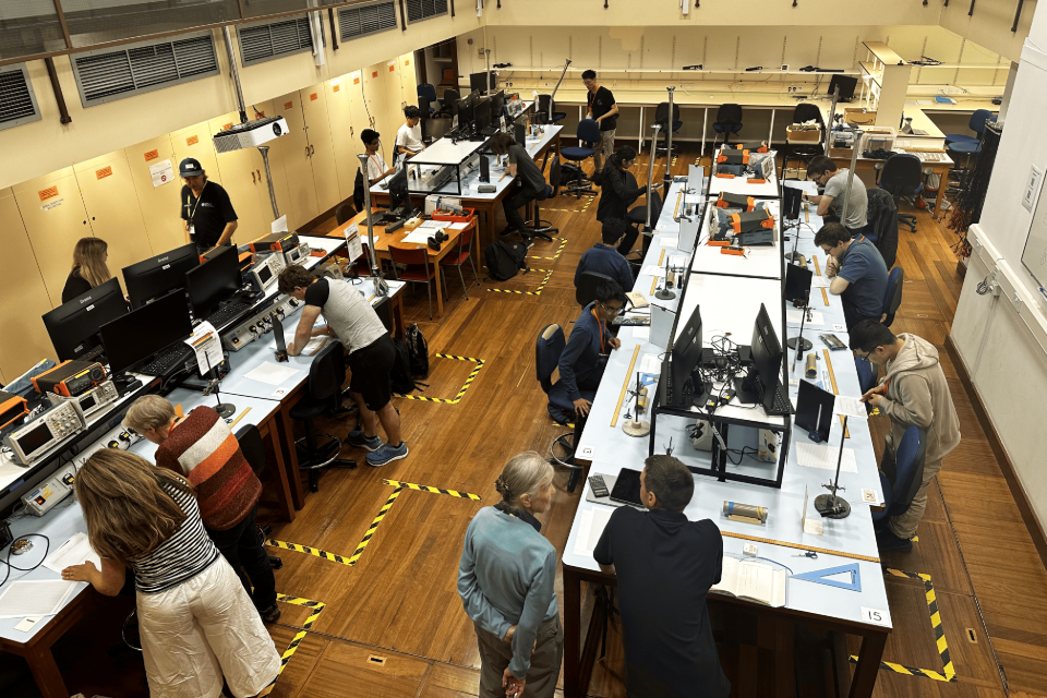 Practical session at the British Physics Olympiad. Students working at tables.
