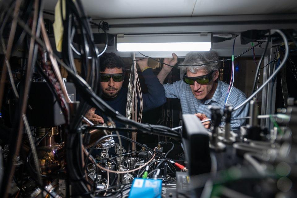 Professor David Lucas, right, at a laser table