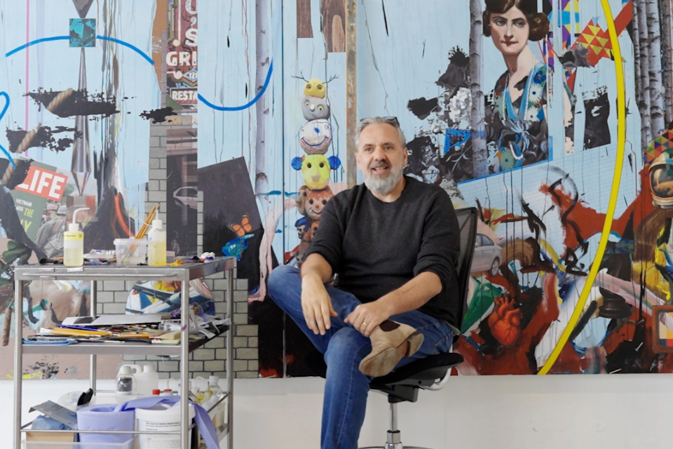 Keith Tyson in front of painting artwork. 