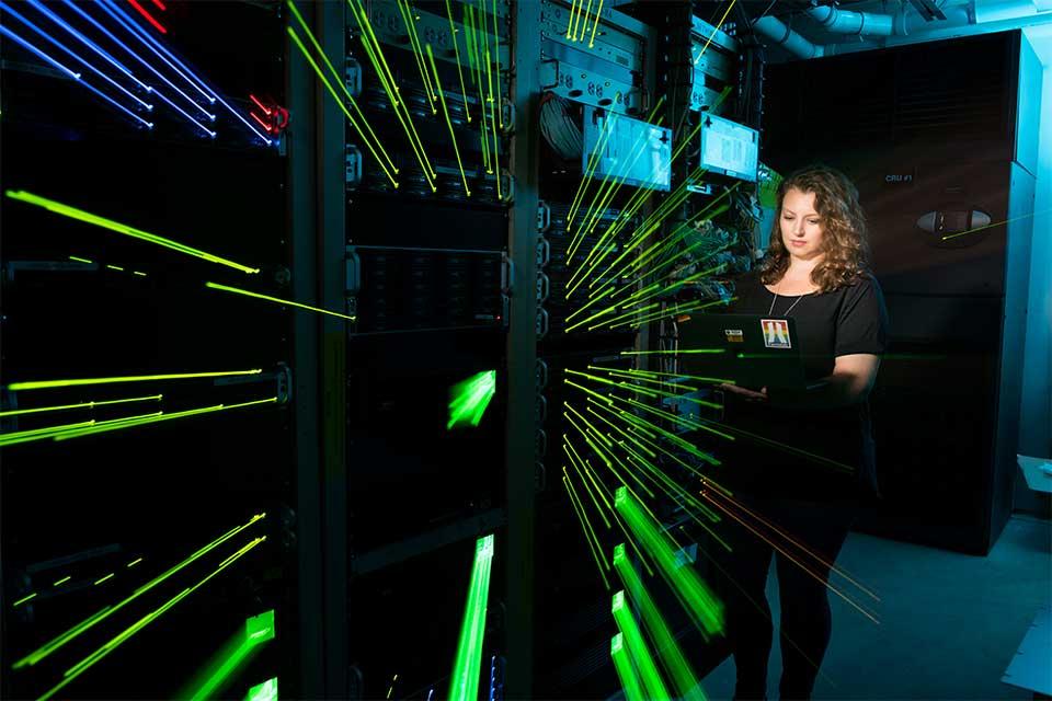 Kirsty Duffy with electronic racks used for MicroBooNE detector