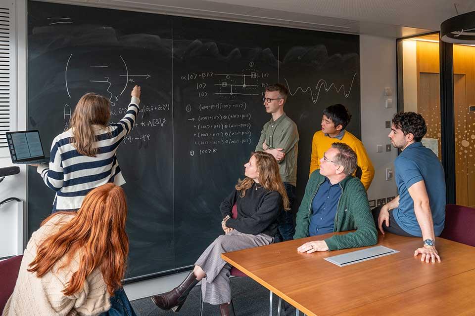 People around blackboard