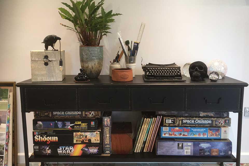 Games piled underneath a console table