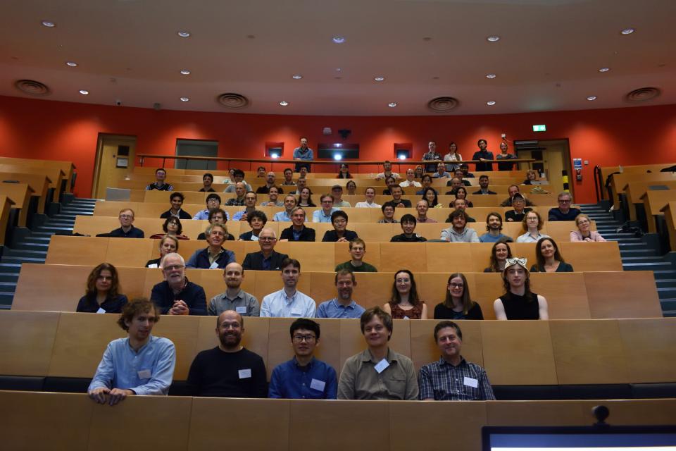 Group photo of participants at Model Uncertainty 2024 workshop sitting in lecture theatre