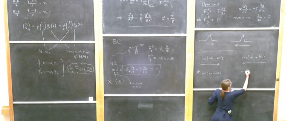 Hannah Christensen writing maths equations on a blackboard