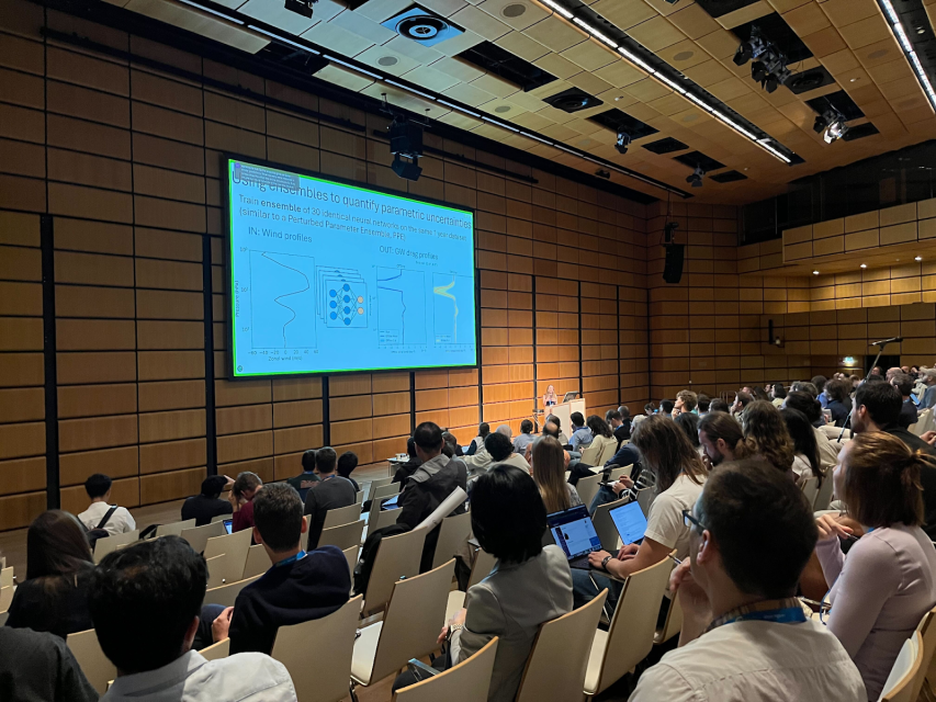 Scientific presentation being given to crowded conference room