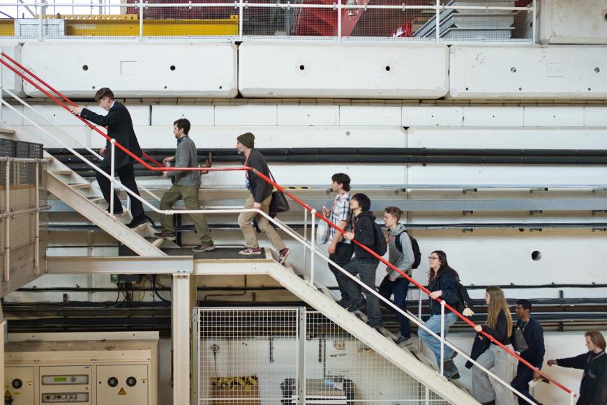 An image of students ascending metal staircase at RAL. 