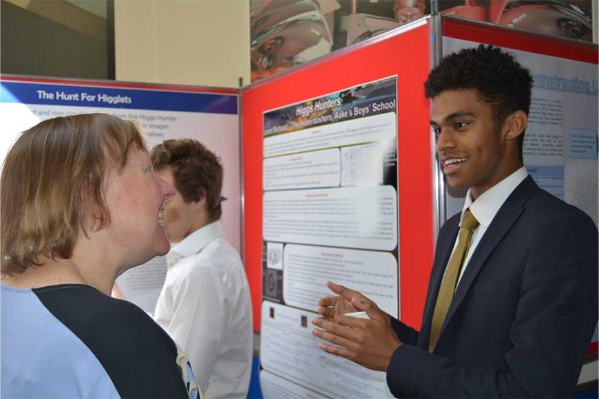 Student and teacher in front of research posters