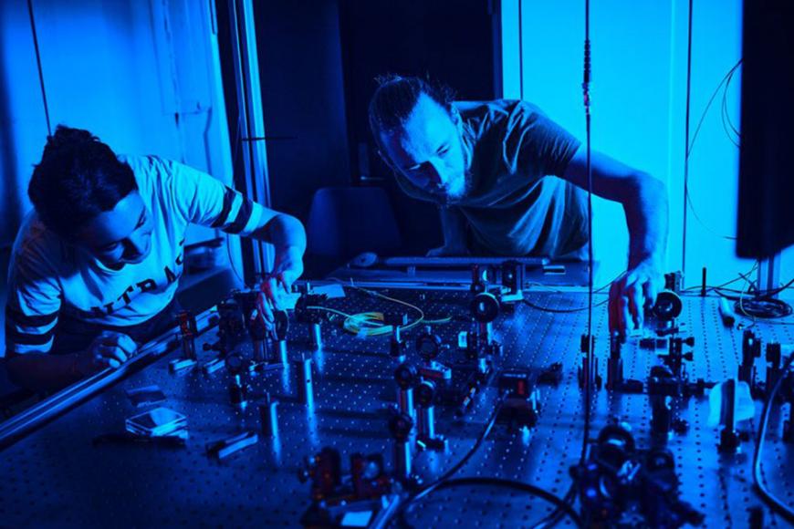 Male and female looking at laser table