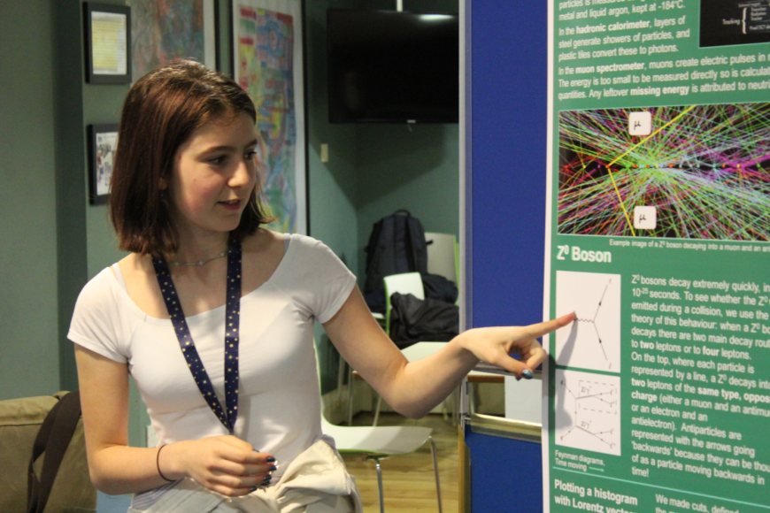 Student presents her project at poster presentation 