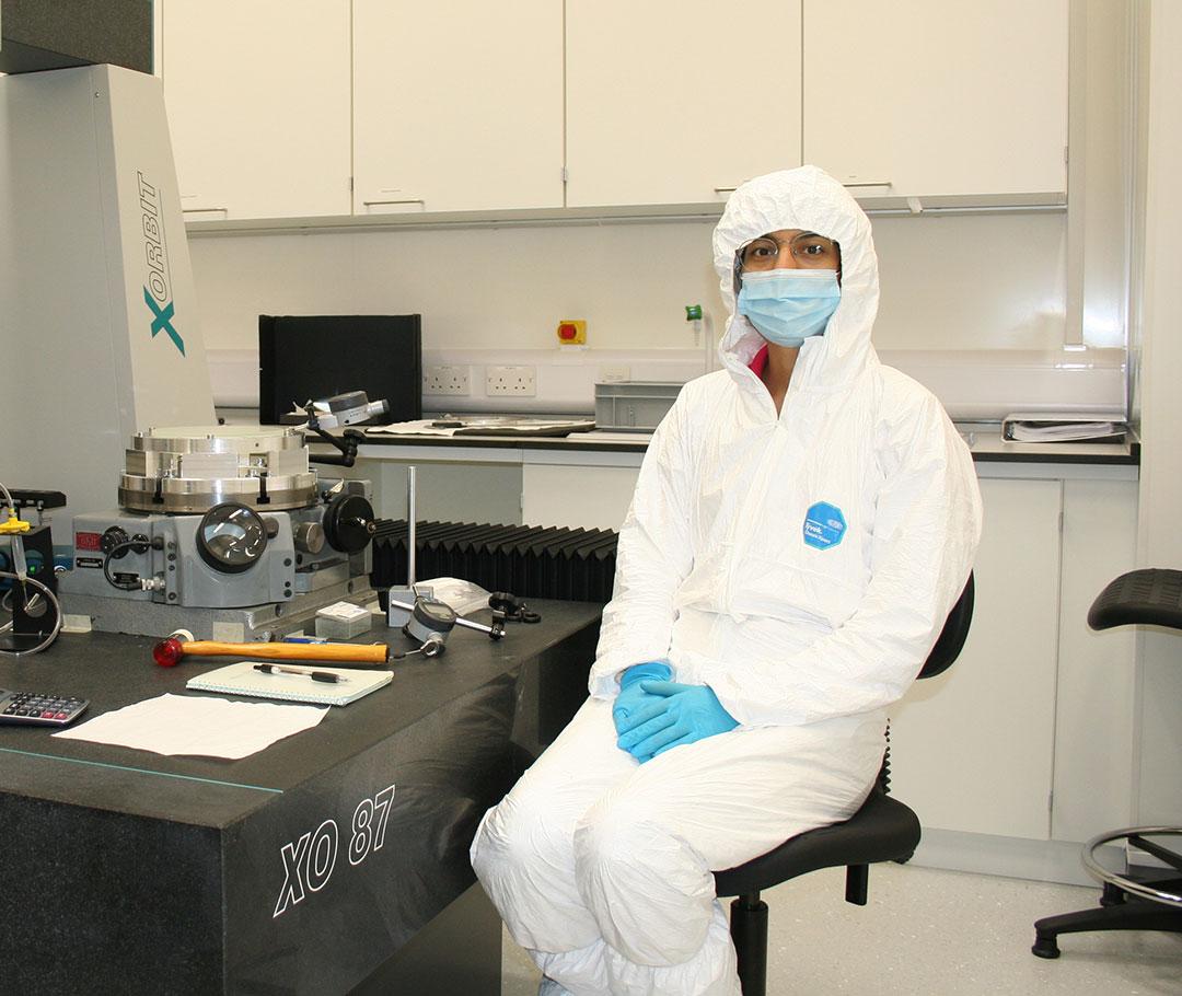 Female student in PPE in clean room environment