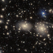 A cluster of galaxies illuminated against the dark sky, showcasing their vibrant colours and intricate formations.