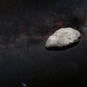 Artist's impression shows a grey, irregularly-shaped asteroid against a dark background.