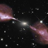 The Very Large Array sees fountains of hot gas erupting from a beastly black hole in the heart of a large galaxy known to radio astronomers as Hercules A. For millions of trillions of miles, these jets shoot through space, finally slowing when they reach ancient gaseous hiccups left behind by this galaxy’s earliest days of star-forming fury.