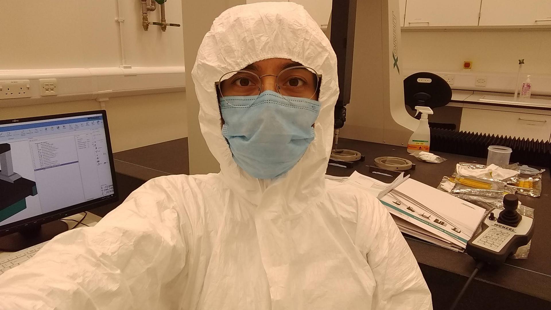 Andrea in the lab in cleanroom suit