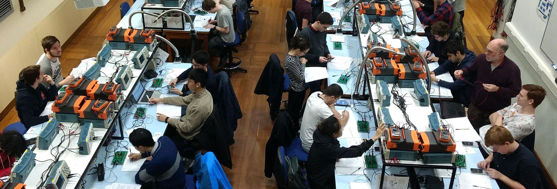 Undergraduate students studying physics in a laboratory