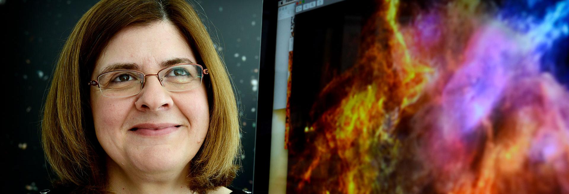 Image shows Prof Dimitra Rigopoulou, smiling, and a computer screen