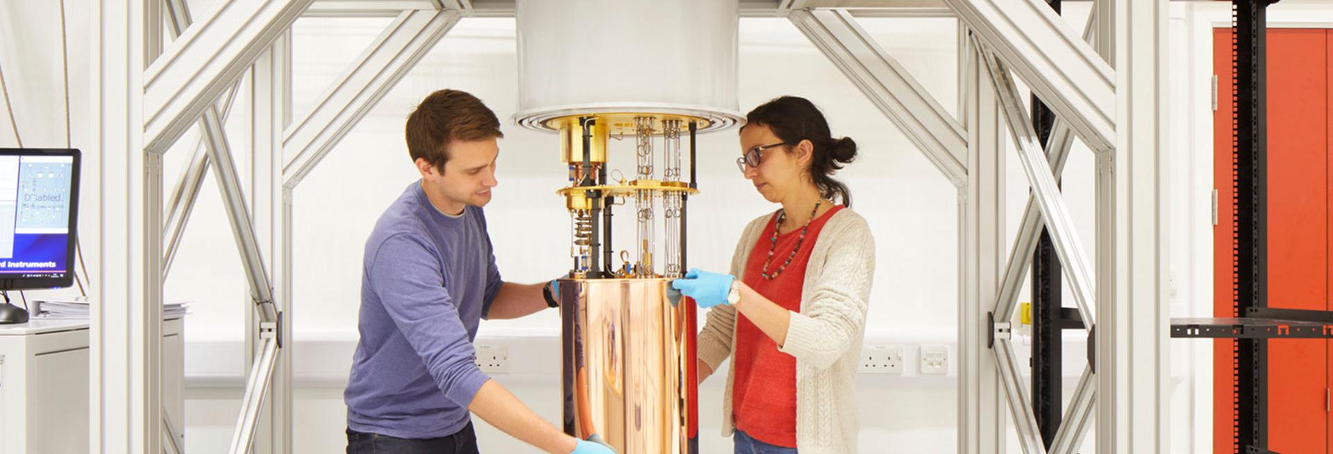 Male and female scientist around science instrument