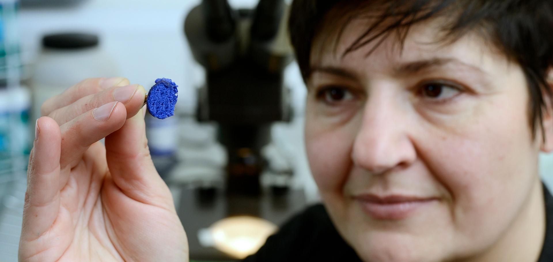 Woman holding matter with tweezers