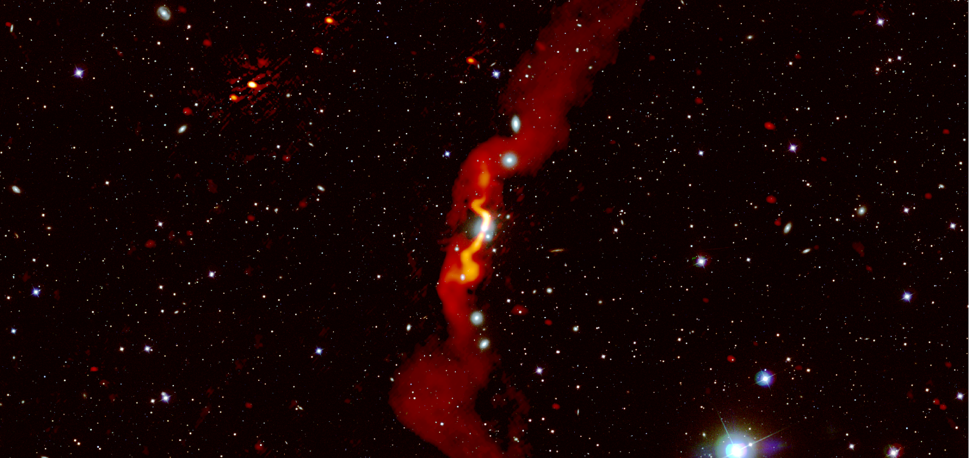 The radio galaxy 3C31, observed with LOFAR, is shown in red on top of an optical image.