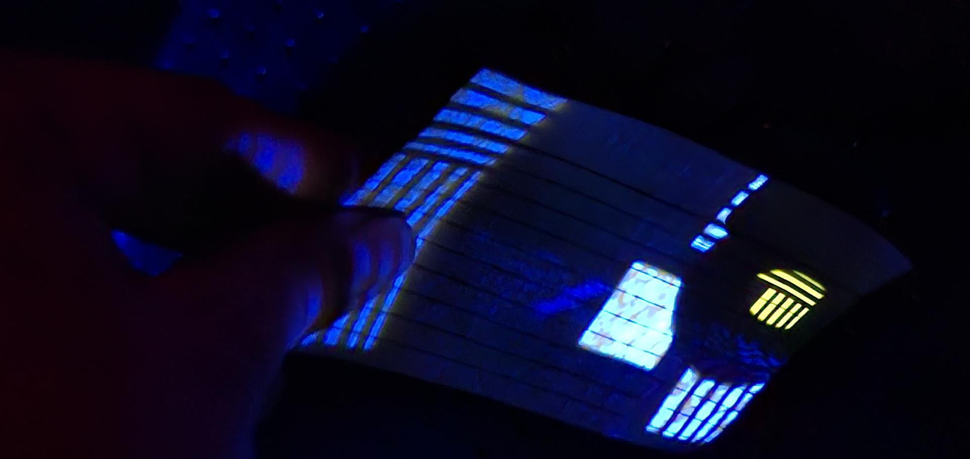 A small card illuminated by light coming from illuminating laser beam and fluorescence light from the sample