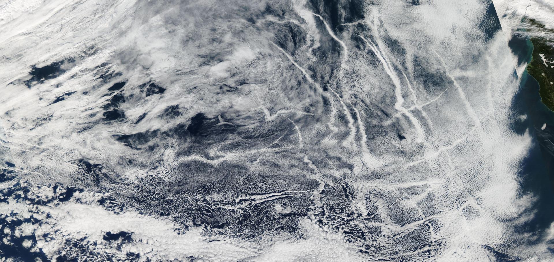 Satellite image showing tracks (long bands of clouds)