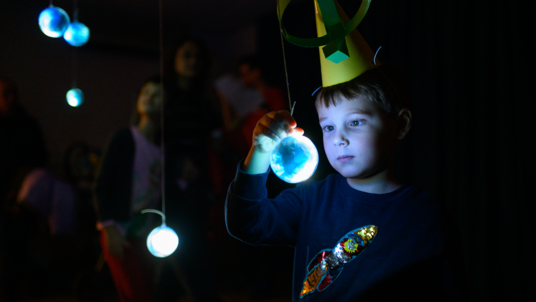 Boy looking at glowing globe