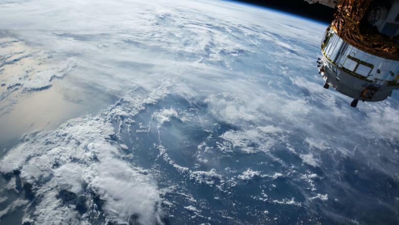 a photo of a satellite above the surface of earth seen from space