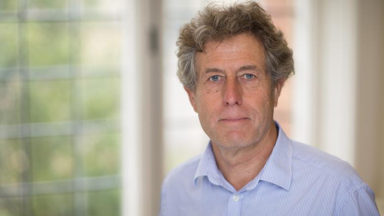 Photograph of Tim Palmer against a leafy background
