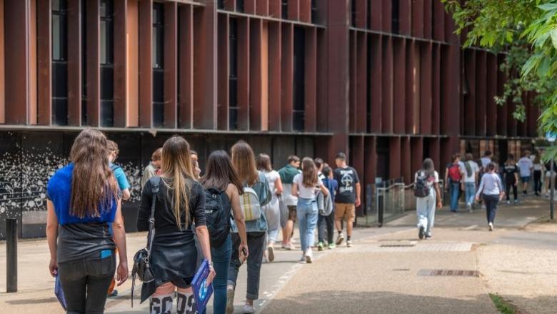Prospective students walking past the Beecroft Building at open day