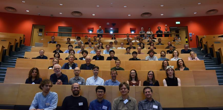 Group photo of participants at Model Uncertainty 2024 workshop sitting in lecture theatre