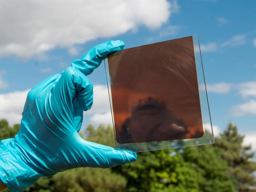 Reflection of smiling face in photovoltaic cell